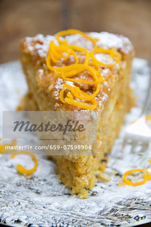 A slice of carrot cake with carrot zest