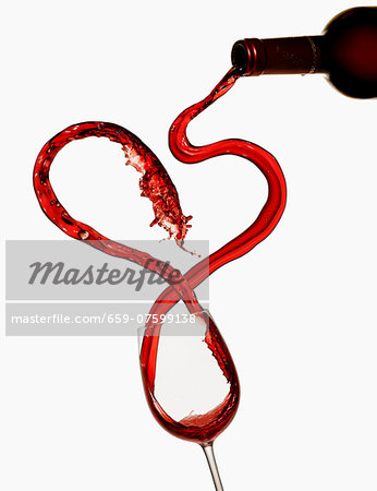 Red wine being poured into a wine glass Red wine being poured into a wine glass