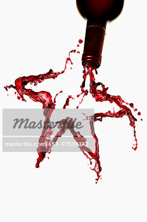 A star made from red wine, against a white background A star made from red wine, against a white background