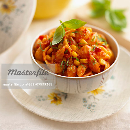 Pasta shells with tomato sauce, sweetcorn and basil