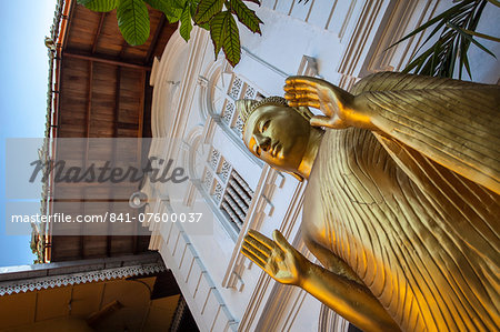 Golden statue at the entrance of Gangaramaya Temple, Colombo, Sri Lanka, Asia