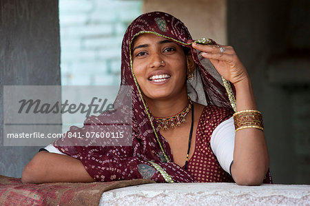 Pretty young Indian woman at home in Narlai village in Rajasthan, Northern India