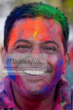 Indian man celebrating annual Hindu Holi festival of colours with powder paints in Mumbai, formerly Bombay, Maharashtra, India