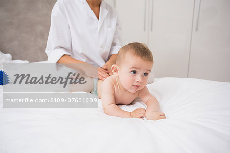 Baby looking away while receiving massage