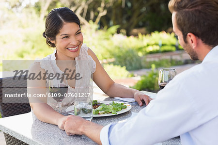 Happy couple holding hands on a date