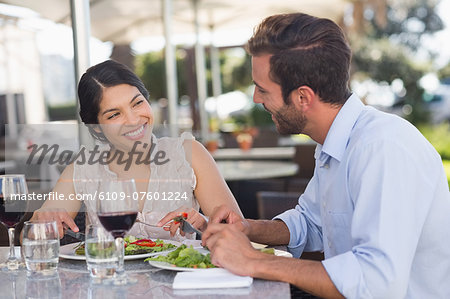 Happy couple on a date having lunch