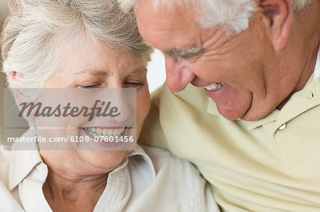 Cheerful senior couple relaxing on the couch together