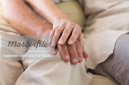 Senior couple holding hands