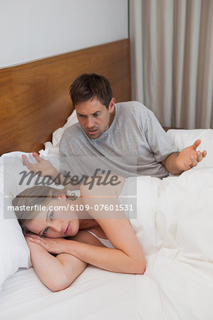 Couple not talking after an argument in bed