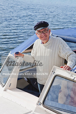 Senior man sailing, Grundsund, Bohuslan, Sweden