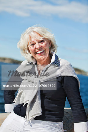 Senior woman looking at camera, Grundsund, Bohuslan, Sweden