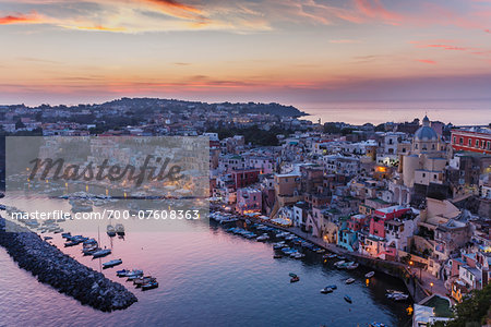 Dusk view of marina and harbour, Corricella, Procida, Gulf of Naples, Campania, Italy.