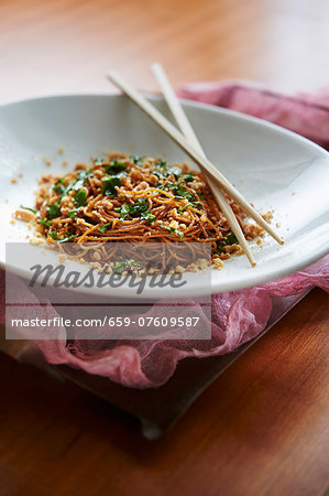 Chilled Sesame Noodles with crumbled roasted peanuts and a mix of basil, cilantro, and parsley