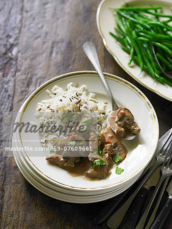 Beef stew with chestnuts in brandy sauce, served with rice and green beans