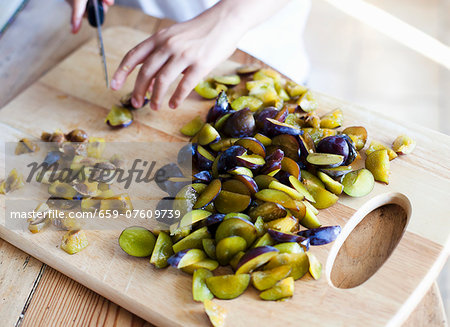 A girl slicing plums