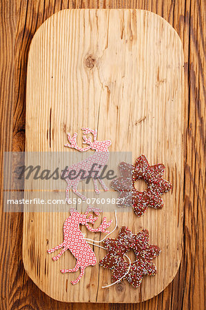 Lebkuchen stars (spiced soft gingerbread from Germany) and Christmas tags on a chopping board