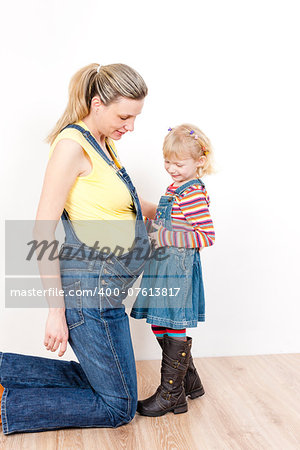 little girl with her pregnant mother