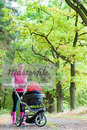 woman with a pram on walk in alley