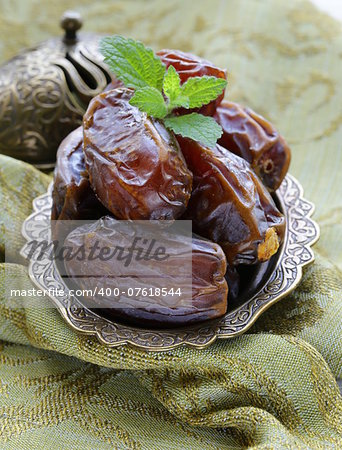 sweet dried dates in bowl on a wooden table