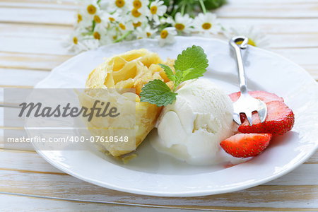 traditional apple strudel with raisins, served with a scoop of ice cream