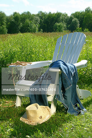 Jeans laying on chair in field