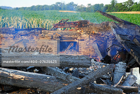 The smoldering remains of a rural home which was completely destroyed by fire.