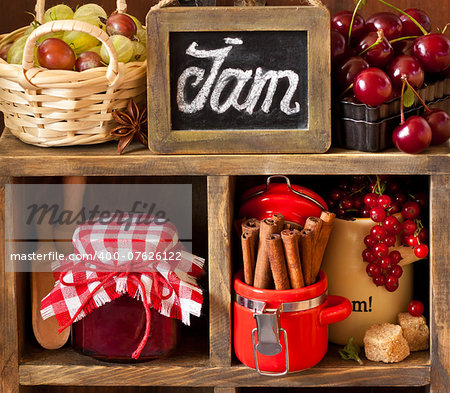 Ingredients for cooking jam. Fresh berries, spices and brown sugar on an old rustic shelves.