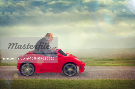 senior man enjoying driving a toy racing car