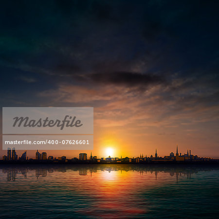 abstract nature background with panorama of city dark clouds and sunset