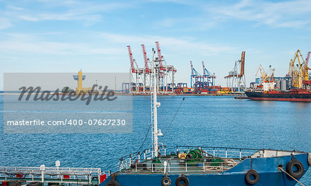 Port cargo crane and container over blue sky background