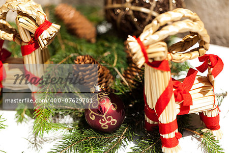 Red Christmas balls with gold design with pine cones in the background