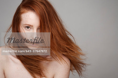 Portrait of young woman, windswept hair