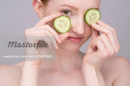 Portrait of young woman, with cucumber eye mask Portrait of young woman, with cucumber eye mask