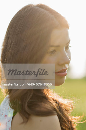 Young brunette woman in sunlight, portrait
