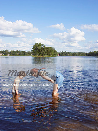 Mother and young son in searching in lake, Gavle, Sweden