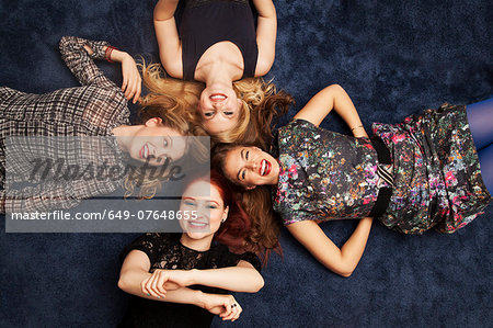 Group of friends lying on carpeted floor