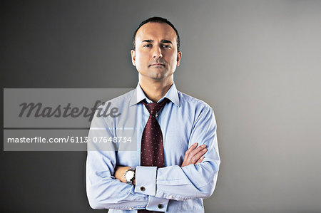 Portrait of confident businessman with arms crossed Portrait of confident businessman with arms crossed