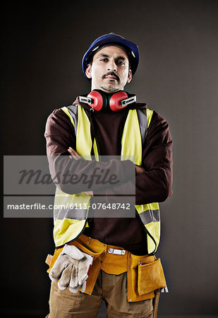 Portrait of serious worker in reflective clothing