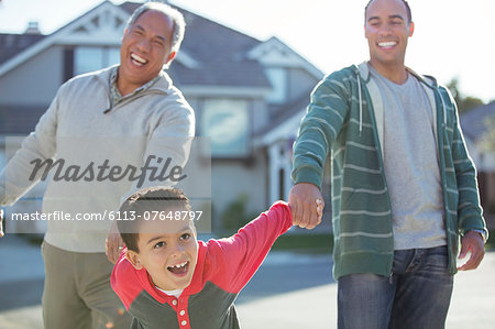 Multi-generation men laughing outdoors