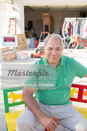 Portrait of smiling man at garage sale