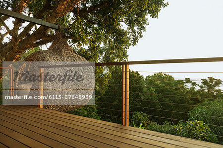 Nest tree house beyond wood deck