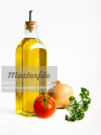 Bottle of oil with a tomato,onion and parsley
