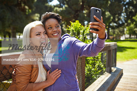 Lesbian couple posing for self portrait in park