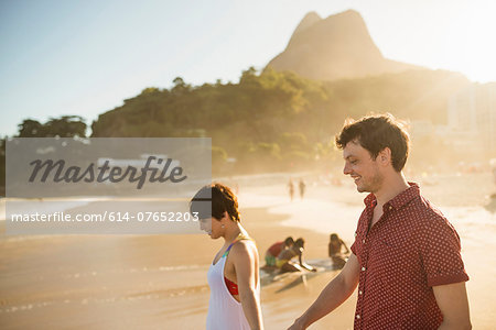 Young couple enjoying sunset, Ipanema Beach, Rio, Brazil