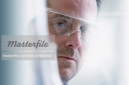 Scientist wearing protective goggles, close-up