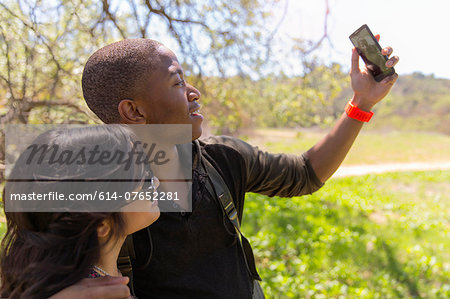 Young couple posing for self portrait in park