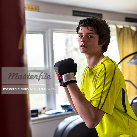 Teenage boy wearing boxing gloves