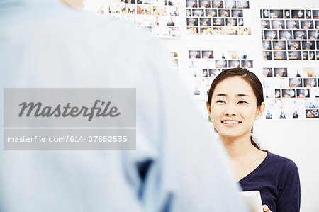 Young woman with colleague in creative studio