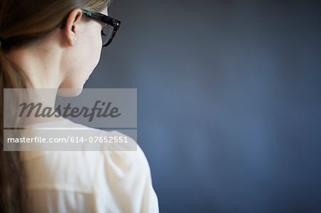 Young woman wearing glasses, studio shot