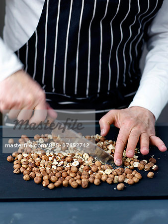 Crushing the hazelnuts with a knife